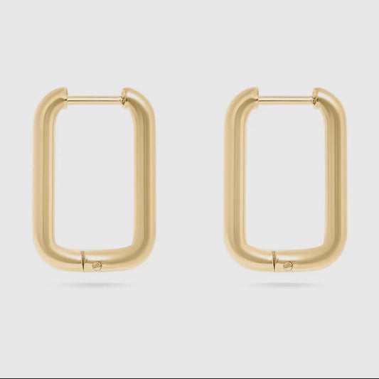 Gold hoop earrings on a light gray background