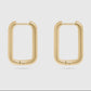 Gold hoop earrings on a light gray background